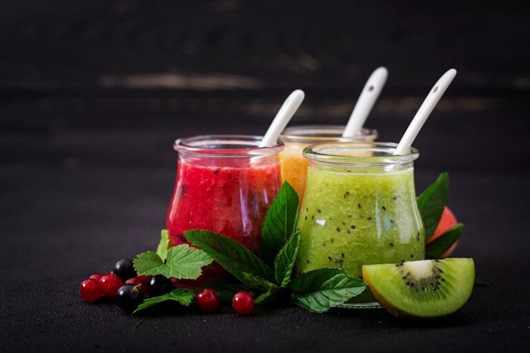 Fresh healthy smoothies from different berries on a dark background. Diet menu. Proper nutrition.